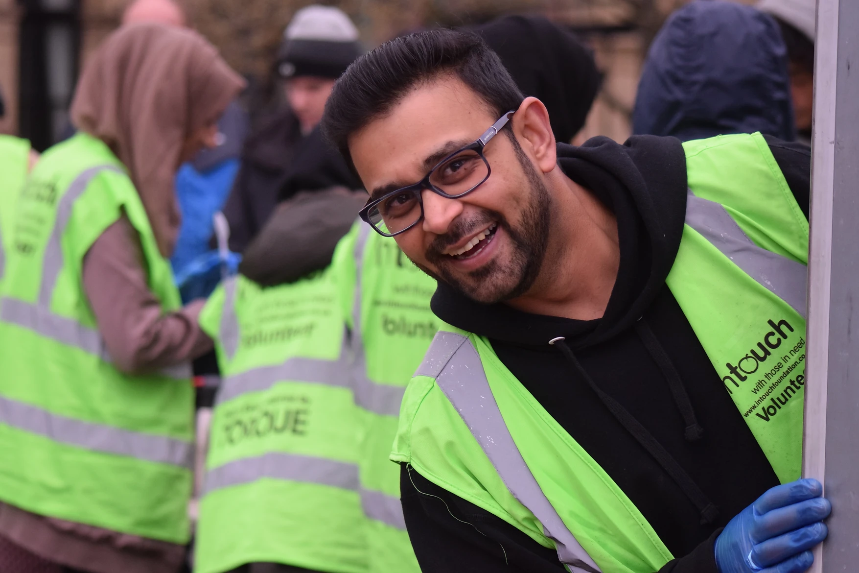 intouch volunteer member Aaamir smiling at the camera