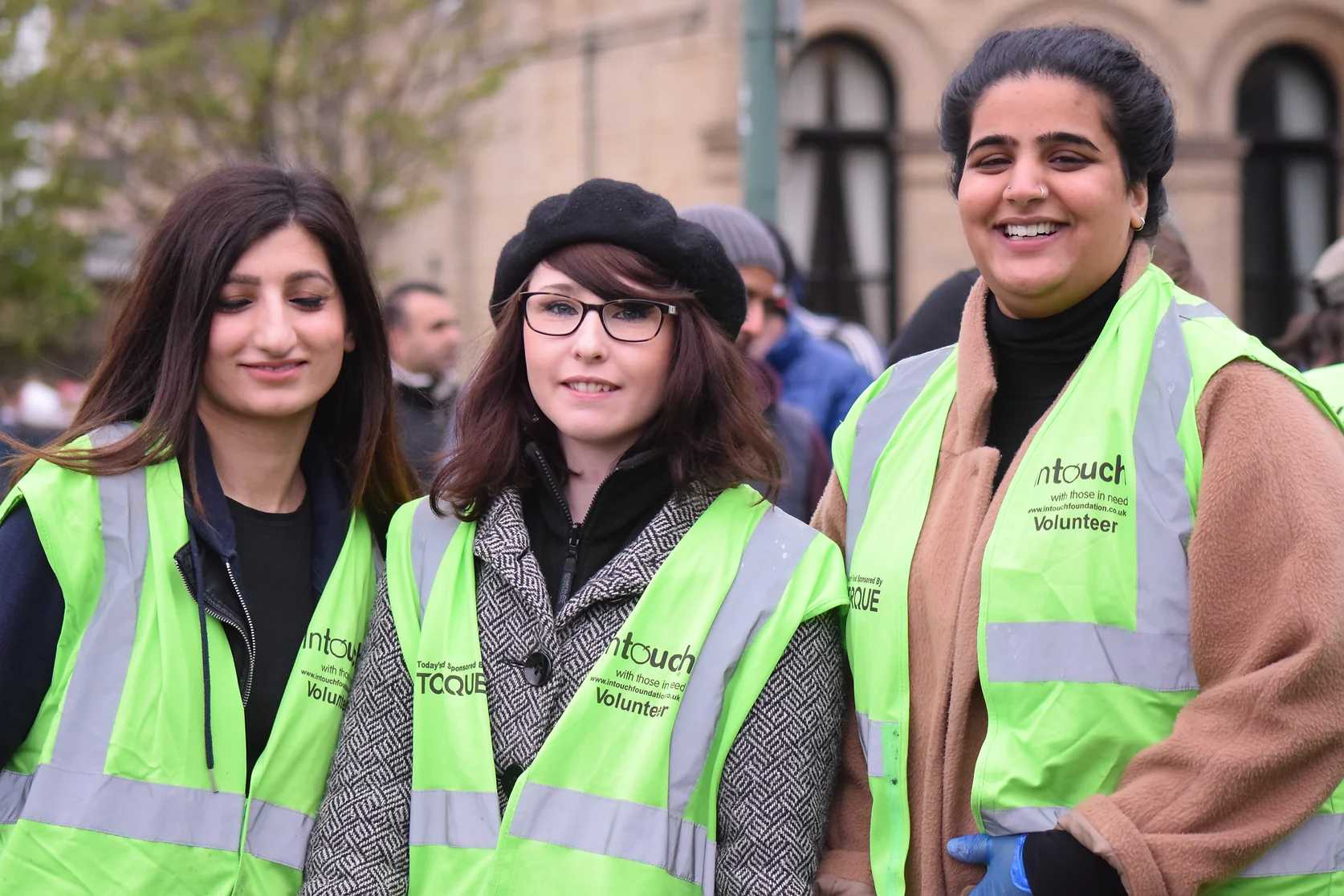 intouch foundation volunteers smiling at the camera